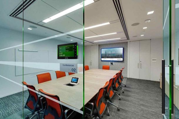 Conference room with a room scheduling panel and video conferencing display