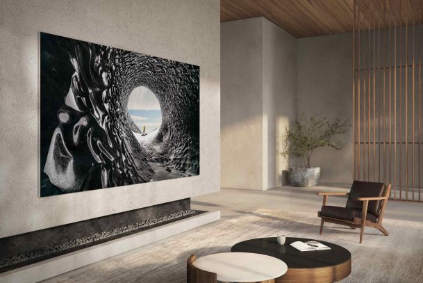 Large wall-mounted TV displaying art in a minimalist modern living room