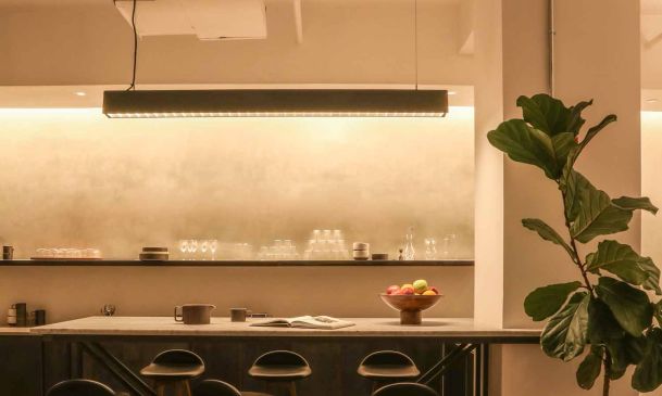 Modern kitchen island with bar stools and warm smart pendant lighting